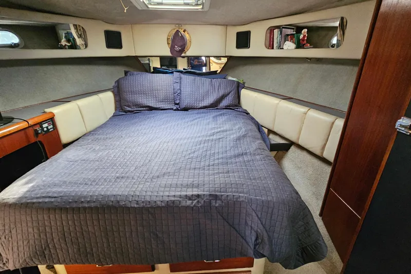 Slide: The Image of Interior cabin of 1991 Bayliner 3888 Motoryacht with cozy bed and wood accents. - 25