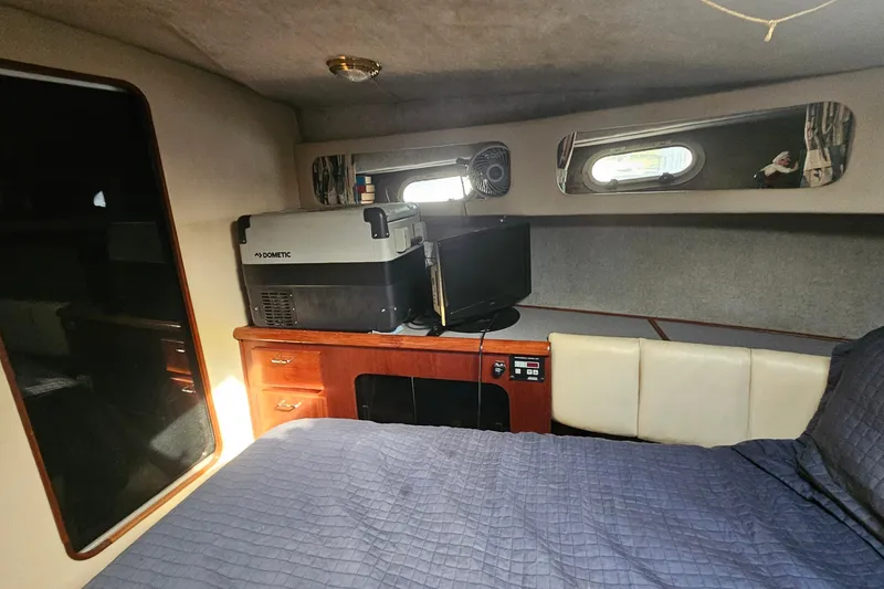 Slide: The Image of Interior cabin of 1991 Bayliner 3888 Motoryacht with bed, TV, and storage. - 26