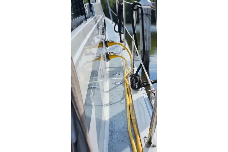 Slide: The Image of Side view of 1991 Bayliner 3888 Motoryacht with yellow cables and dock ropes. - 32