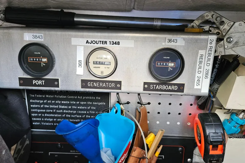 Slide: The Image of Control panel of a 1991 Bayliner 3888 Motoryacht with hour meters and tools. - 38