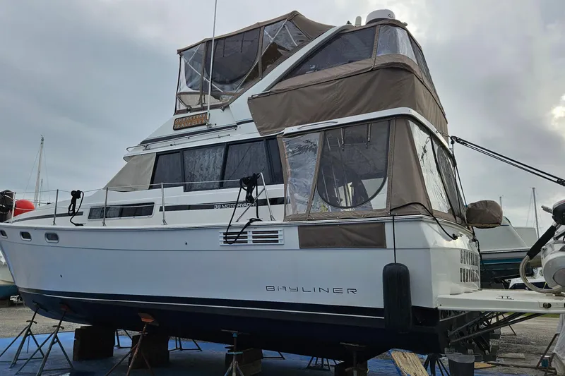 Slide: The Image of 1991 Bayliner 3888 Motoryacht view from cockpit, docked near another boat. - 4