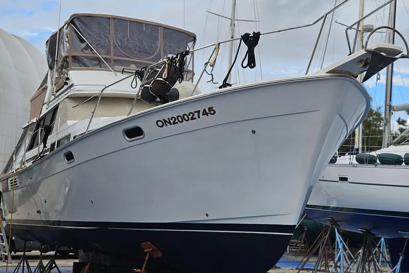 Slide: The Image of 1991 Bayliner 3888 Motoryacht deck with fenders and calm water reflection. - 6