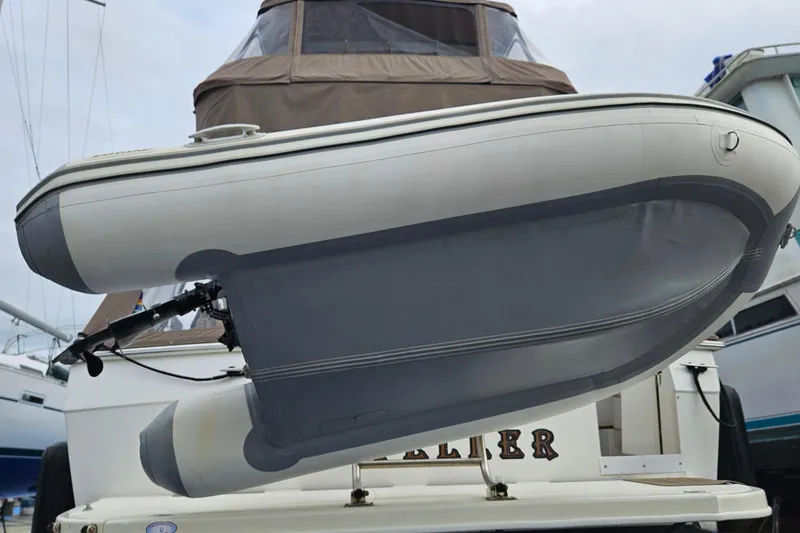 Slide: The Image of Luxurious interior of 1991 Bayliner 3888 Motoryacht with plush seating and wooden table. - 9