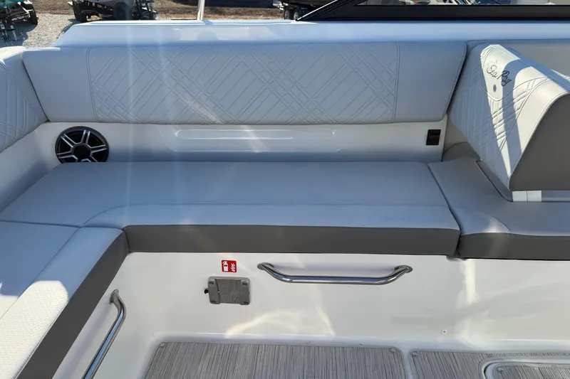 Slide: The Image of 2026 Sea Ray SDX 230 boat interior with cushioned seating and speaker. - 10