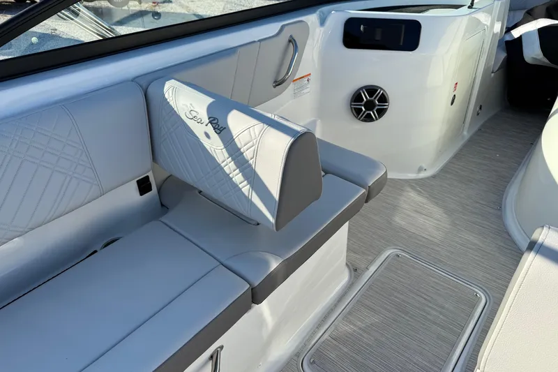 Slide: The Image of 2026 Sea Ray SDX 230 boat interior with white seating and speaker detail. - 13