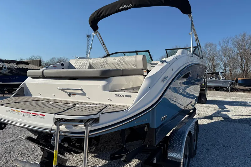 Slide: The Image of 2026 Sea Ray SDX 230 boat on trailer, rear view, sunny day. - 6