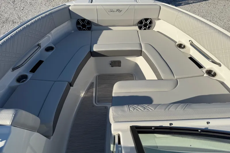 Slide: The Image of 2026 Sea Ray SDX 230 boat interior with luxurious seating and cup holders. - 11
