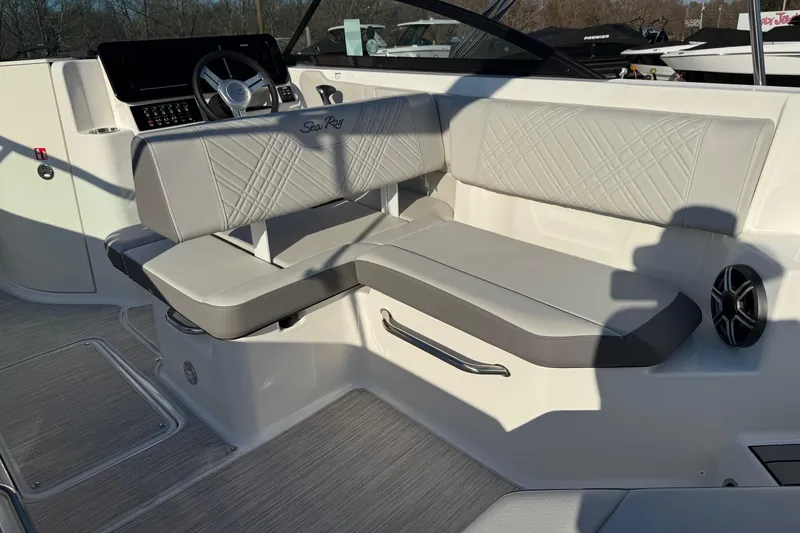 Slide: The Image of 2026 Sea Ray SDX 230 boat interior with luxurious seating and modern dashboard. - 9