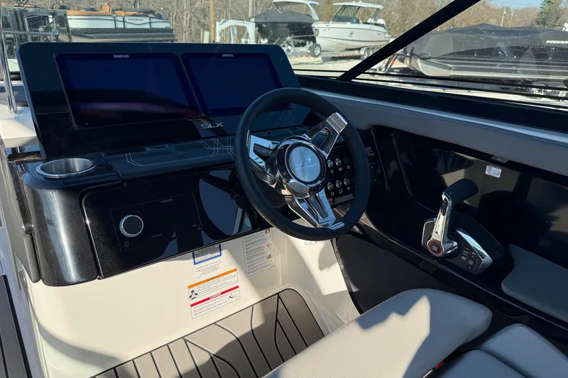 Slide: The Image of 2026 Sea Ray SLX 280 boat dashboard with steering wheel and control panel. - 19