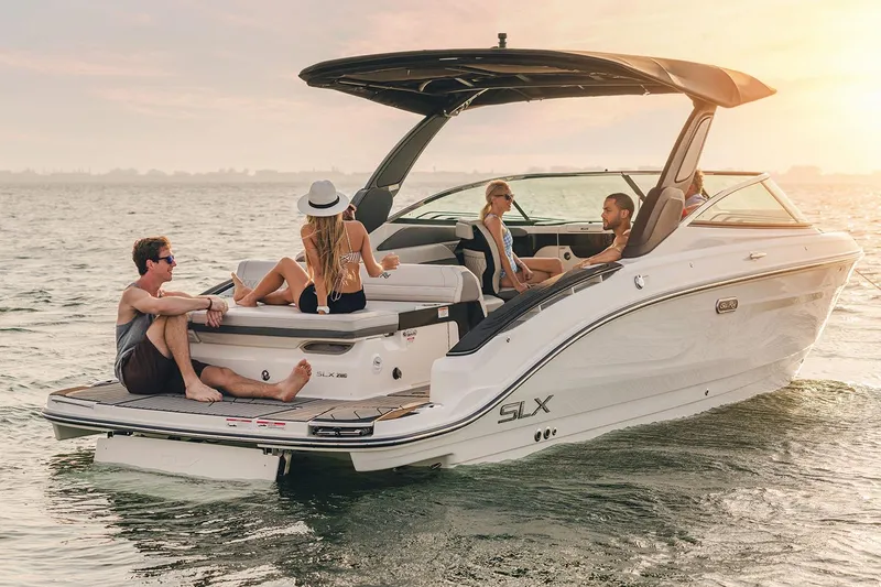 Slide: The Image of 2026 Sea Ray SLX 280 boat on trailer under clear blue sky. - 6