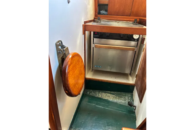Slide: The Image of Compact kitchen area in a 1968 Spencer 35 boat, featuring a stainless steel stove. - 16