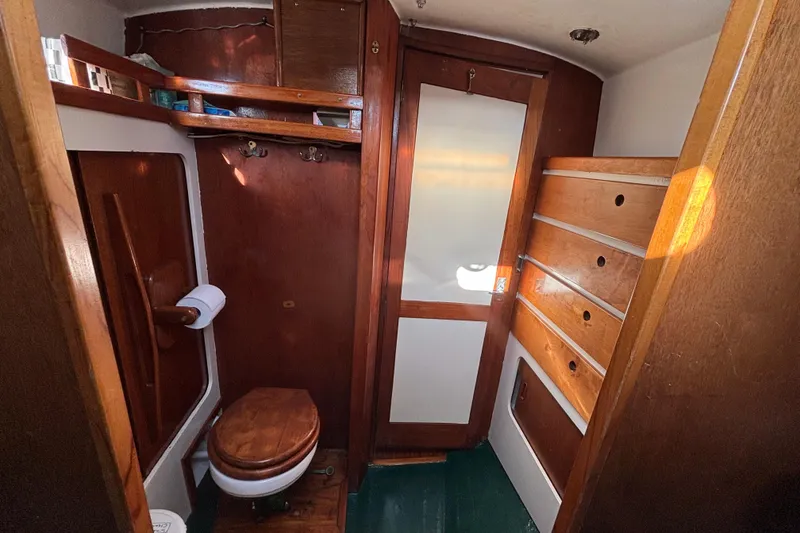 Slide: The Image of Vintage 1968 Spencer 35 yacht bathroom with wooden cabinetry and compact design. - 22