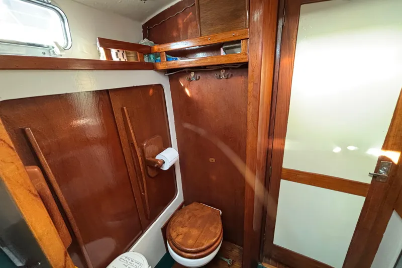 Slide: The Image of 1968 Spencer 35 yacht bathroom with wooden interior and compact design. - 23
