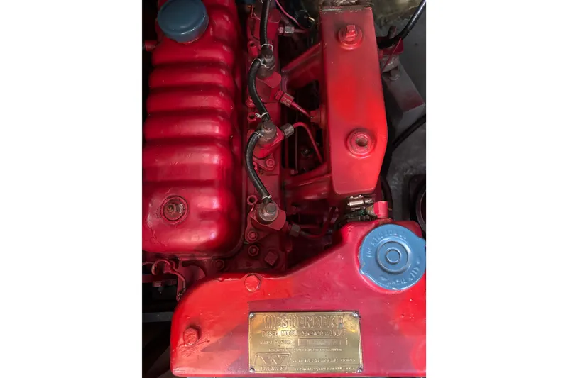 Slide: The Image of Red Spencer 35 engine from 1968 with visible components and blue cap. - 26