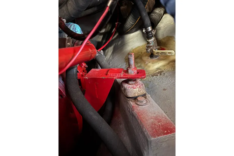 Slide: The Image of Close-up of a 1968 Spencer 35 engine component with red metal parts and hoses. - 28