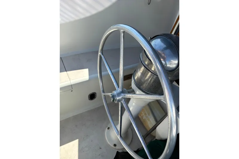 Slide: The Image of Steering wheel of a 1968 Spencer 35 boat, showcasing vintage nautical design. - 34