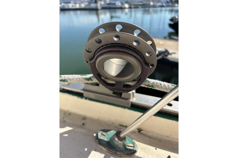 Slide: The Image of Close-up of a 1968 Spencer 35 sailboat fitting with marina background. - 37