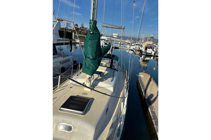 Slide: The Image of 1968 Spencer 35 sailboat docked in a marina, clear sky reflection on water. - 4
