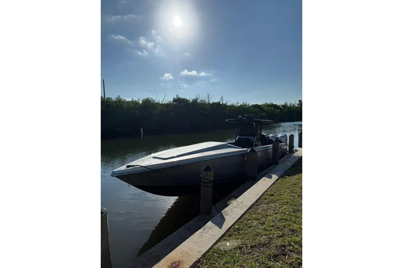 Slide: The Image of Boat docked by a river under a bright sun, Lazer 40 model, 2006. - 11