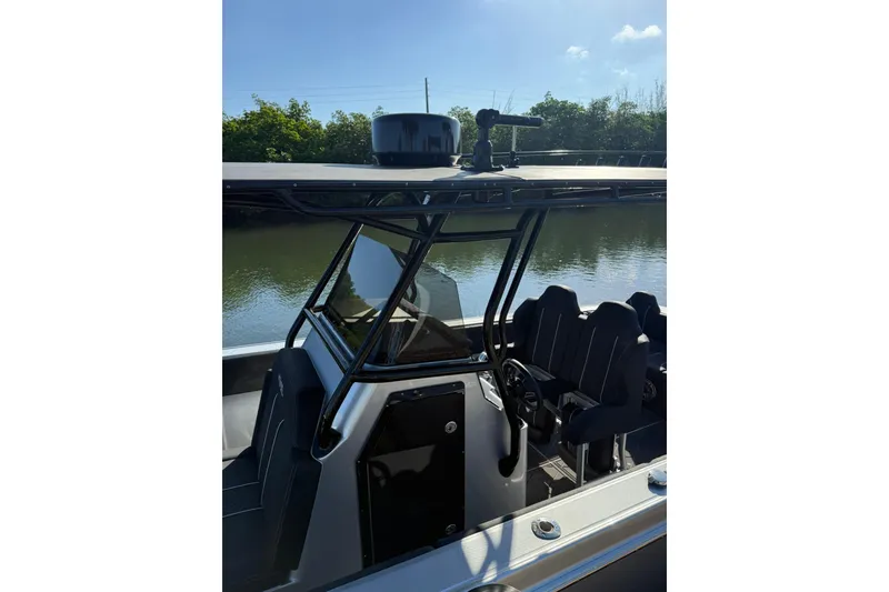 Slide: The Image of 2006 Lazer 40 boat cockpit with seating, docked by a calm river. - 15