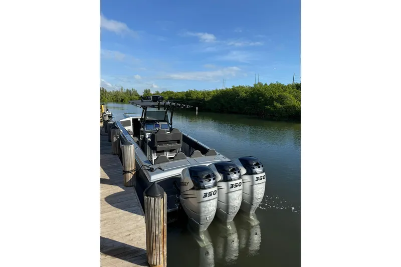 Slide: The Image of 2006 Lazer 40 boat with triple 350 horsepower engines docked on a sunny day. - 19