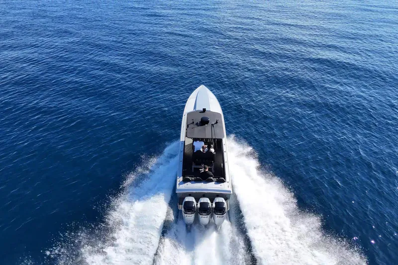 Slide: The Image of Aerial view of 2006 Lazer 40 speedboat cruising on open blue water. - 2