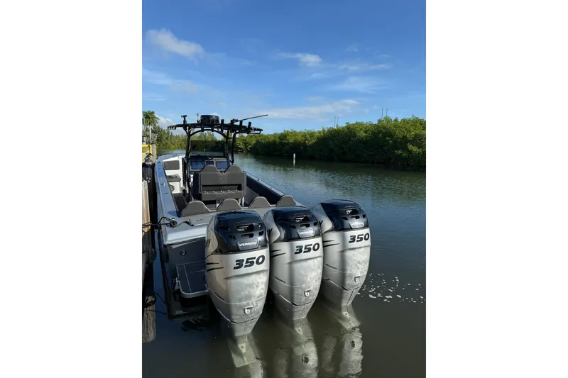 Slide: The Image of 2006 Lazer 40 boat with triple 350 horsepower engines on a calm waterway. - 20