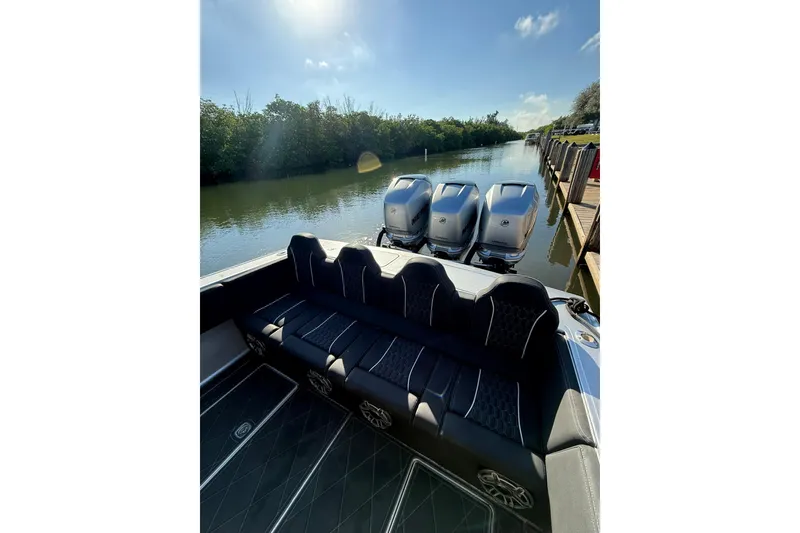 Slide: The Image of Luxury 2006 Lazer 40 boat with triple outboard engines docked on a sunny day. - 23