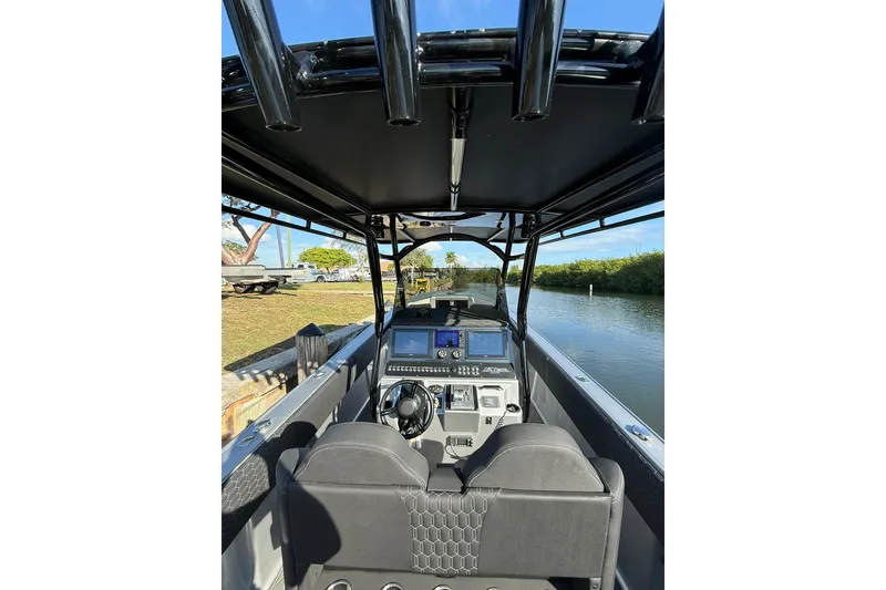 Slide: The Image of Interior view of a 2006 Lazer 40 boat with modern dashboard and steering wheel. - 26