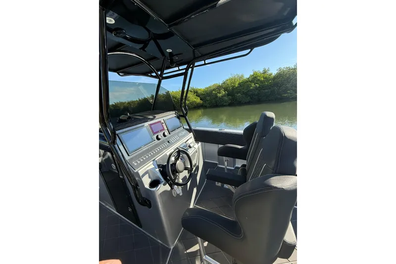 Slide: The Image of Interior view of a 2006 Lazer 40 boat cockpit with modern controls and seating. - 28