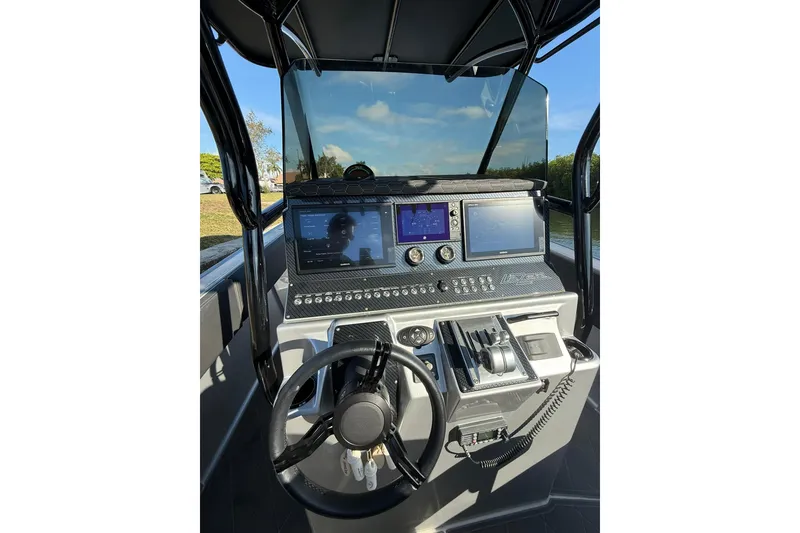 Slide: The Image of Control panel of a 2006 Lazer 40 boat with steering wheel and navigation screens. - 29