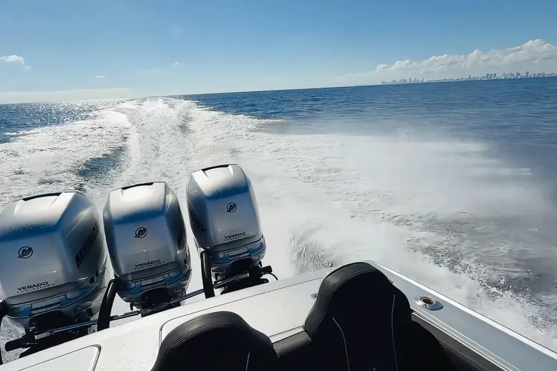 Slide: The Image of Powerful Lazer 40 boat with triple Mercury Verado engines cruising on open water, 2006 model. - 3