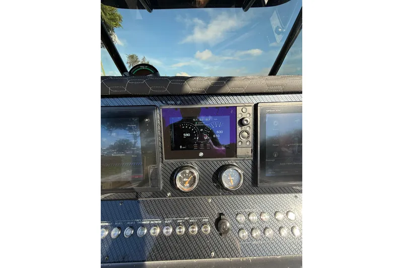 Slide: The Image of Dashboard of a 2006 Lazer 40 boat with digital displays and controls. - 31