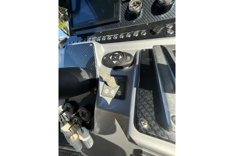 Slide: The Image of Control panel of a 2006 Lazer 40 boat with various switches and gauges. - 34