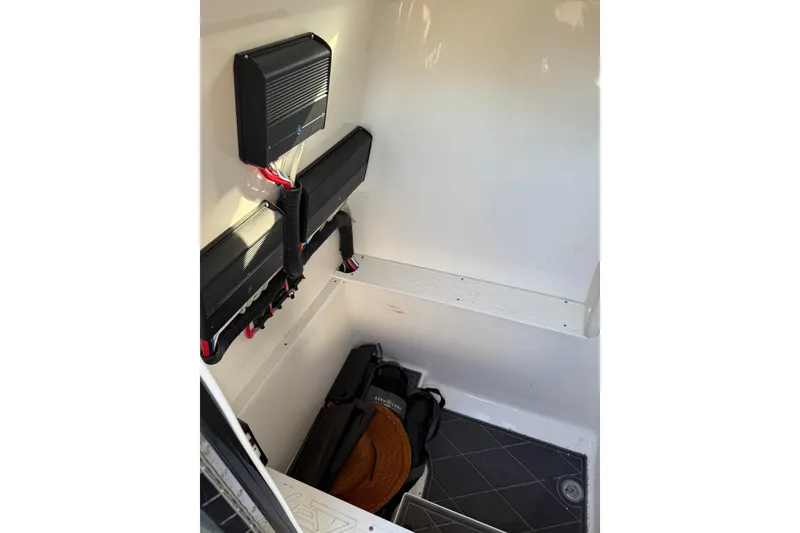 Slide: The Image of Interior of a 2006 Lazer 40 boat showing electrical components and storage area. - 36