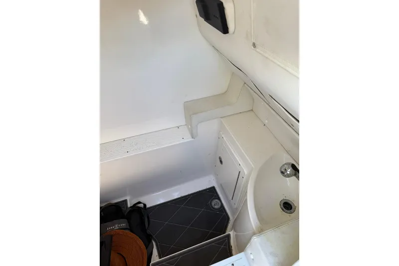 Slide: The Image of Interior of 2006 Lazer 40 boat, featuring compact sink and storage area. - 37