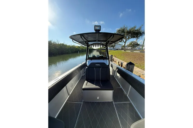 Slide: The Image of 2006 Lazer 40 boat interior with seating, docked by a serene waterway. - 41