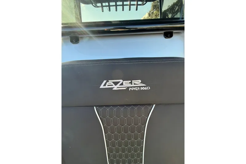 Slide: The Image of 2006 Lazer 40 boat seat with logo and hexagonal pattern design. - 42