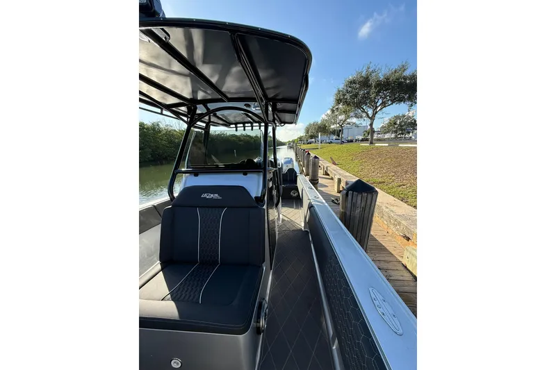 Slide: The Image of 2006 Lazer 40 boat docked by a canal under a clear blue sky. - 44