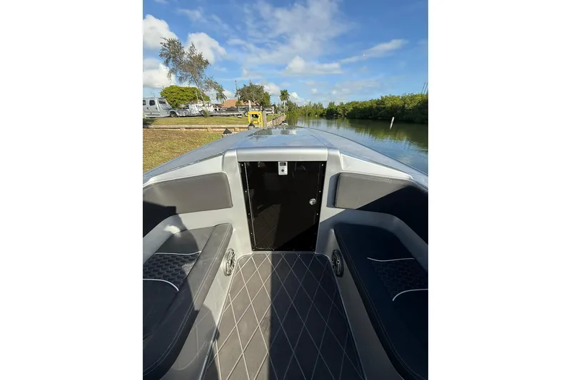 Slide: The Image of 2006 Lazer 40 boat interior with sleek seating and scenic waterway view. - 49