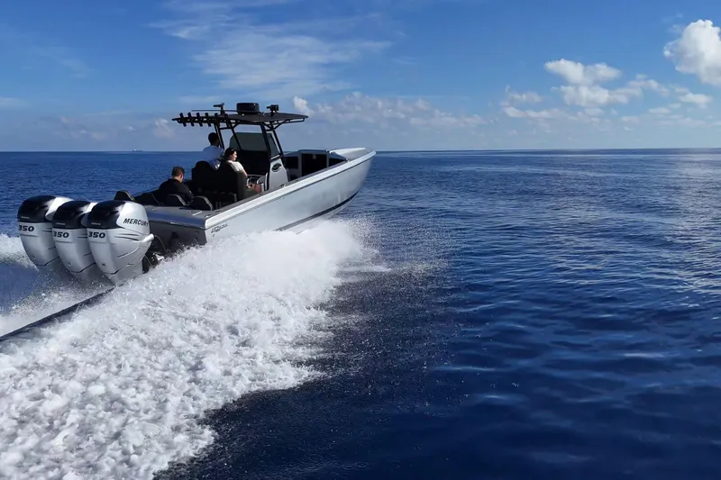 Slide: The Image of High-speed Lazer 40 boat cruising on open sea, 2006 model, with triple Mercury engines. - 5