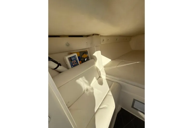 Slide: The Image of Interior cabin of 2006 Lazer 40 boat with white seating and storage. - 53