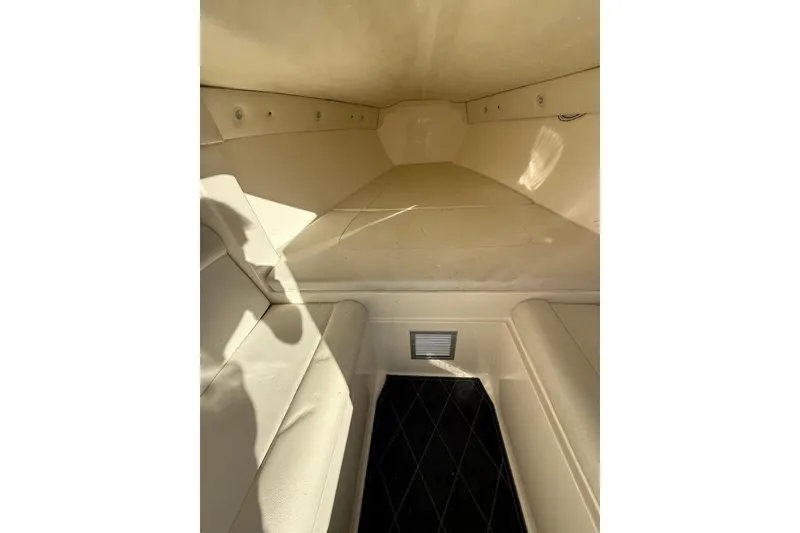 Slide: The Image of Interior cabin of 2006 Lazer 40 boat, featuring beige seating and compact design. - 54