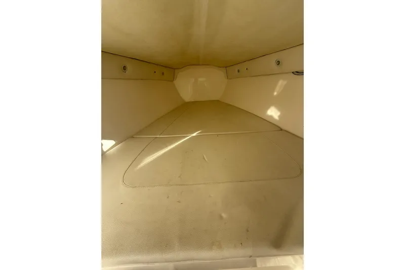 Slide: The Image of Interior cabin of a 2006 Lazer 40 boat, featuring beige upholstery. - 55