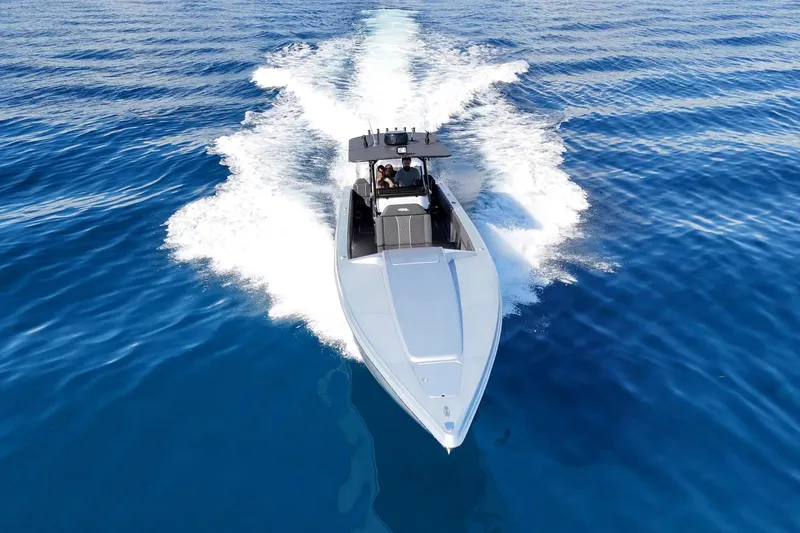 Slide: The Image of 2006 Lazer 40 speedboat cruising on clear blue ocean waters. - 6