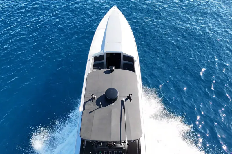 Slide: The Image of Aerial view of 2006 Lazer 40 boat cruising on clear blue water. - 7
