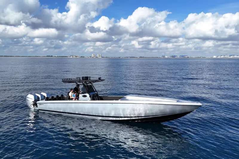 Slide: The Image of 2006 Lazer 40 boat on open water under a partly cloudy sky. - 8
