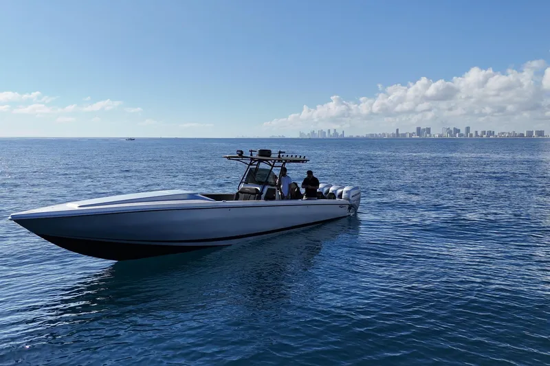 Slide: The Image of A 2006 Lazer 40 boat on calm ocean waters with city skyline in the background. - 9