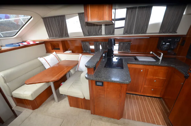 Slide: The Image of Interior of 2007 Cruisers Yachts 415 Express Motoryacht with kitchen and dining area. - 14