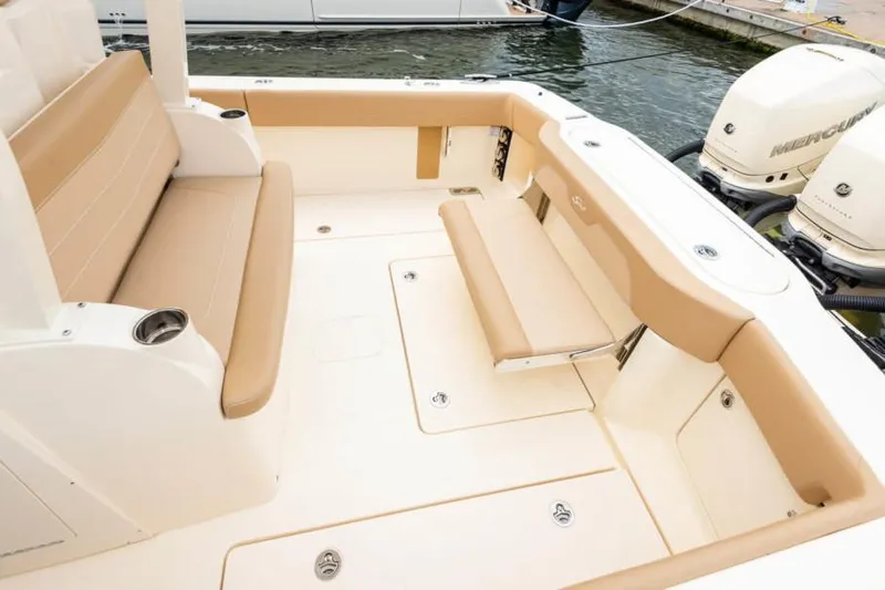 Slide: The Image of Manufacturer Provided Image: 2021 Scout 355 LXF boat interior with beige seating and dual Mercury outboard engines. - 104